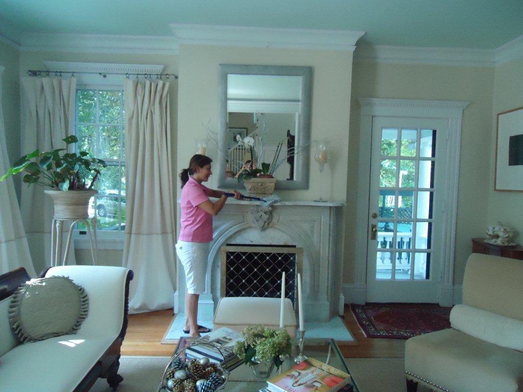 Cleaning a living room mantel and surrounding details